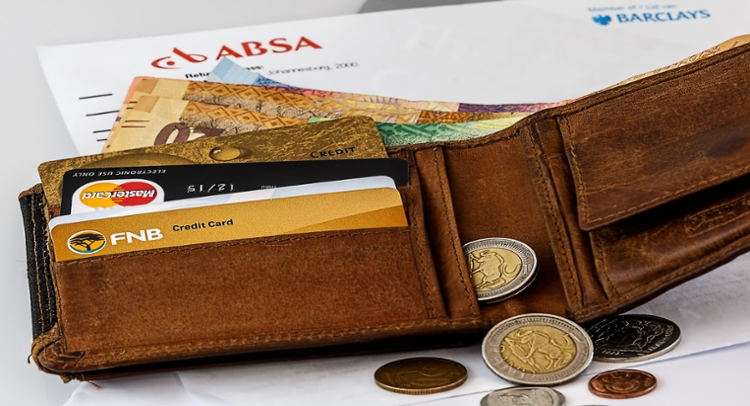 A number of payment methods float around a person. These payment methods include images of visa and other logos.